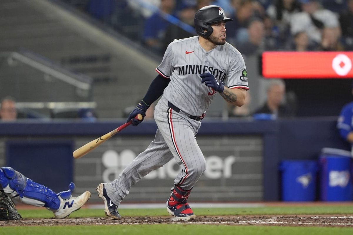 Apr 12, 2026; Toronto, Ontario, CAN; Minnesota Twins catcher Victor Caratini (37) hits a single against the Toronto Blue Jays during the eighth inning at Rogers Centre. Mandatory Credit: John E. Sokolowski-Imagn Images