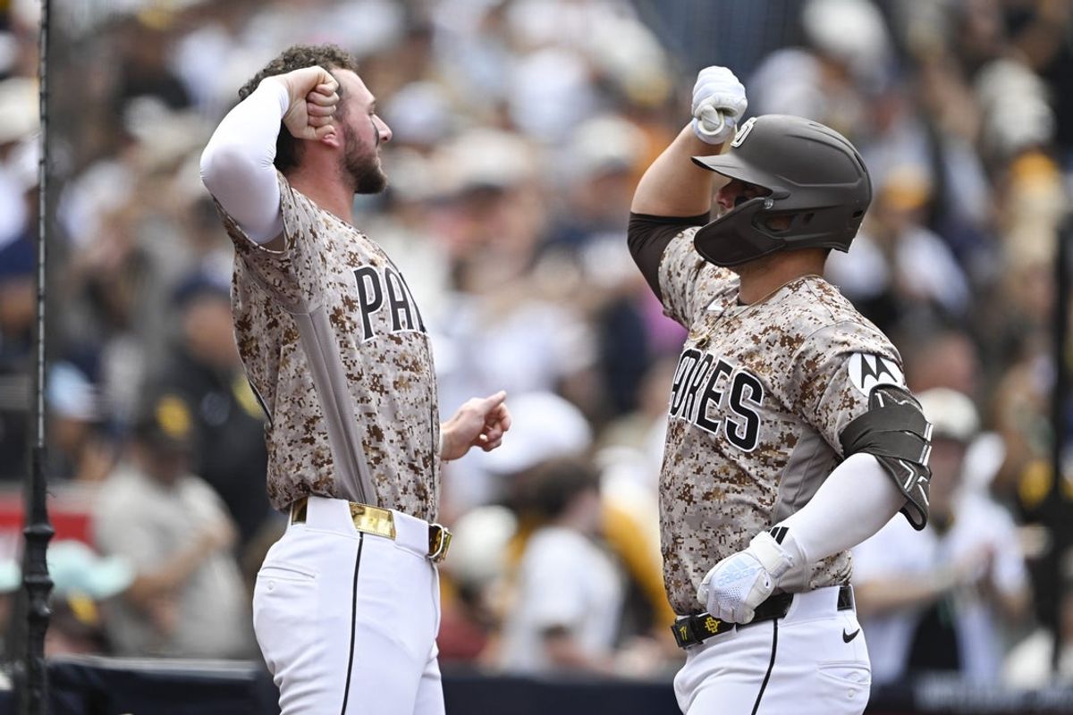 Apr 12, 2026; San Diego, California, USA; San Diego Padres first baseman Ty France (25), right, is congratulated by center fielder Jackson Merrill (3) after hitting a solo home run during the fourth inning against the Colorado Rockies at Petco Park. Mandatory Credit: Denis Poroy-Imagn Images