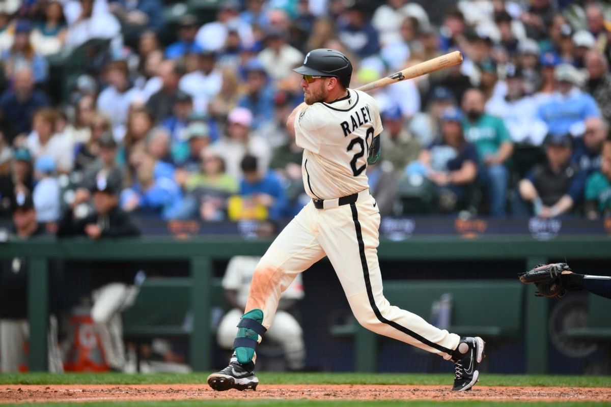 Apr 12, 2026; Seattle, Washington, USA; Seattle Mariners right fielder Luke Raley (20) hits a single against the Houston Astros during the fifth inning at T-Mobile Park. Mandatory Credit: Steven Bisig-Imagn Images