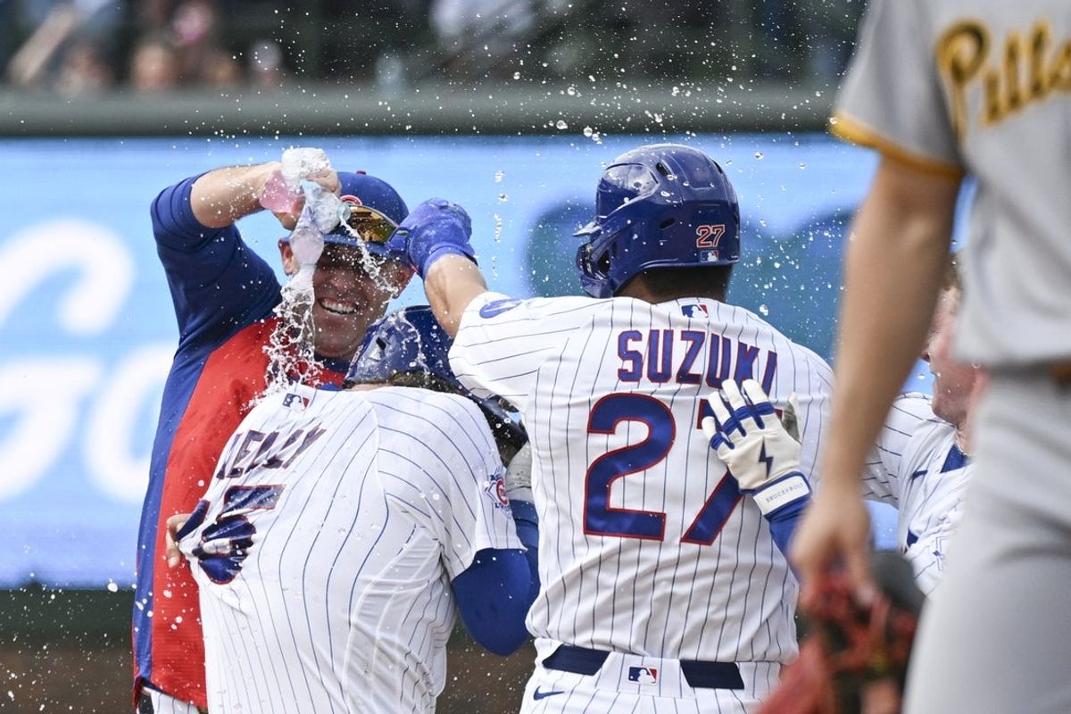 Apr 12, 2026; Chicago, Illinois, USA;  Chicago Cubs right fielder Seiya Suzuki (27) celebrates with catcher Carson Kelly (15) after he hit a walk off RBI single during the ninth inning against the Pittsburgh Pirates at Wrigley Field. Mandatory Credit: Matt Marton-Imagn Images