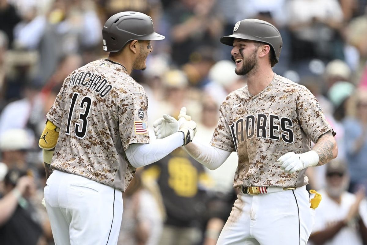 Apr 12, 2026; San Diego, California, USA; San Diego Padres center fielder Jackson Merrill (3), right, is congratulated by third baseman Manny Machado (13) after hitting a solo home run during the seventh inning against the Colorado Rockies at Petco Park. Mandatory Credit: Denis Poroy-Imagn Images