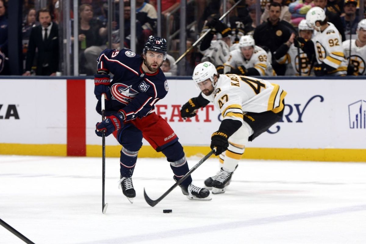 Apr 12, 2026; Columbus, Ohio, USA; Columbus Blue Jackets center Adam Fantilli (19) takes the puck away from Boston Bruins center Mark Kastelic (47) during the first period at Nationwide Arena. Mandatory Credit: Russell LaBounty-Imagn Images