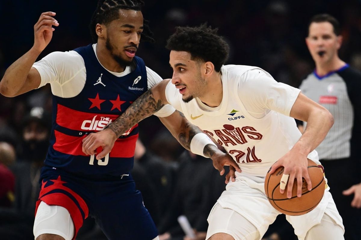 Apr 12, 2026; Cleveland, Ohio, USA; Cleveland Cavaliers guard Tyrese Proctor (24) drives to the basket against Washington Wizards guard Sharife Cooper (13) during the first half at Rocket Arena. Mandatory Credit: Ken Blaze-Imagn Images