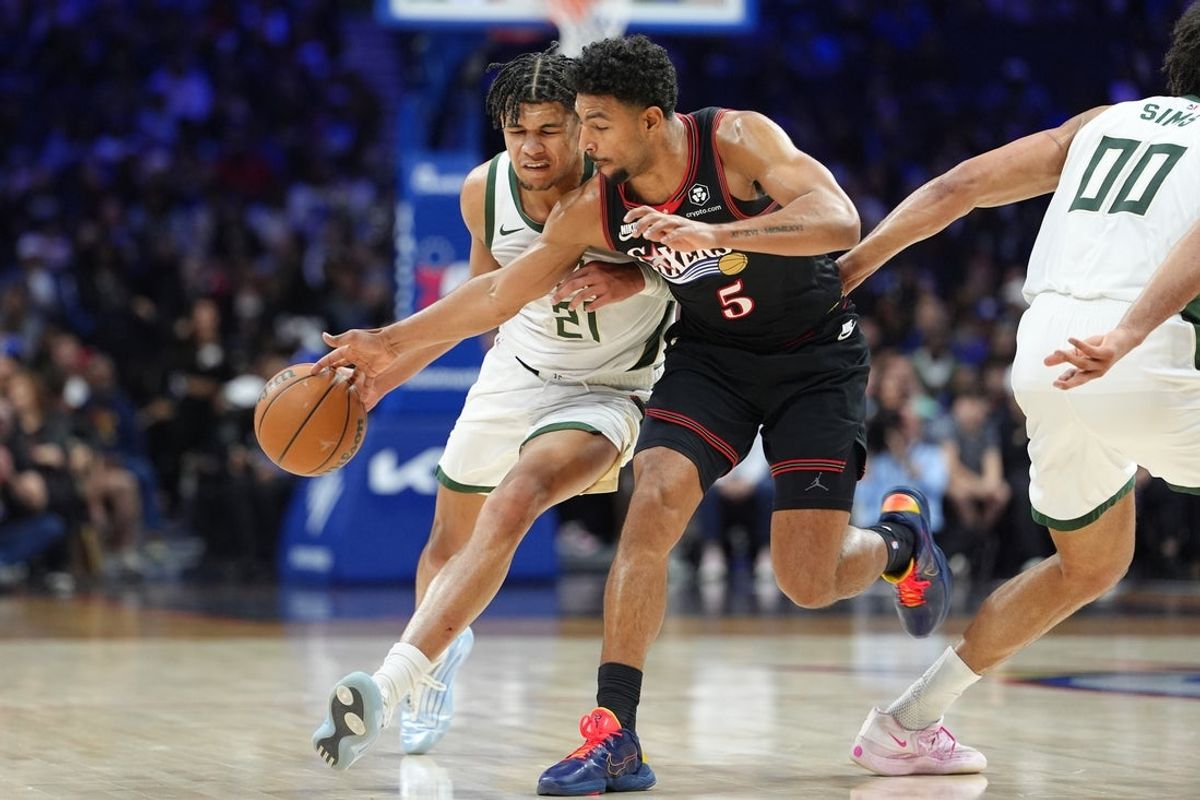 Apr 12, 2026; Philadelphia, Pennsylvania, USA; Philadelphia 76ers guard Quentin Grimes (5) reaches in against Milwaukee Bucks forward Ousmane Dieng (21) in the second quarter at Xfinity Mobile Arena. Mandatory Credit: Kyle Ross-Imagn Images