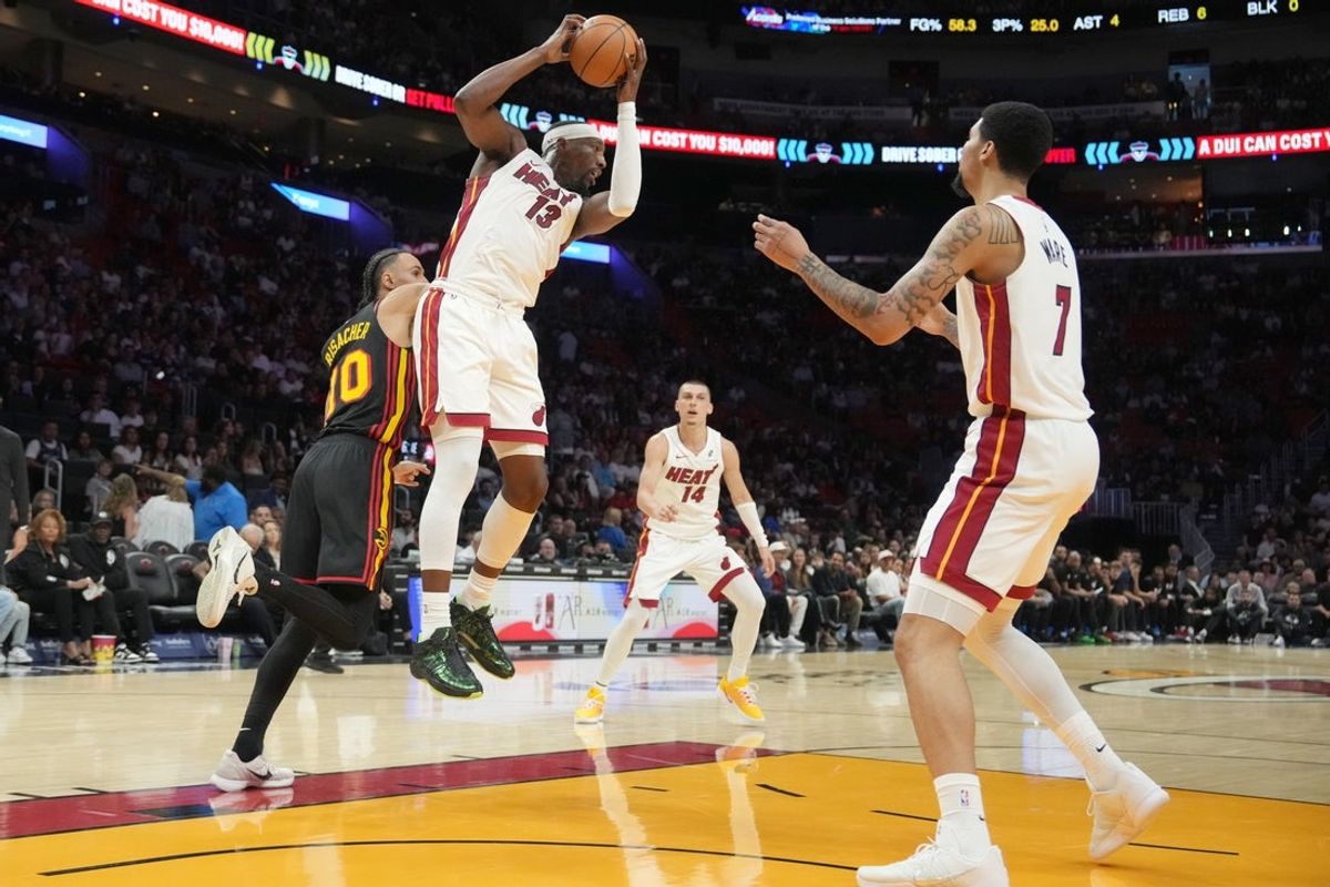 Apr 12, 2026; Miami, Florida, USA;  Miami Heat center Bam Adebayo (13) grabs a rebound against the Atlanta Hawks during the first half at Kaseya Center. Mandatory Credit: Jim Rassol-Imagn Images