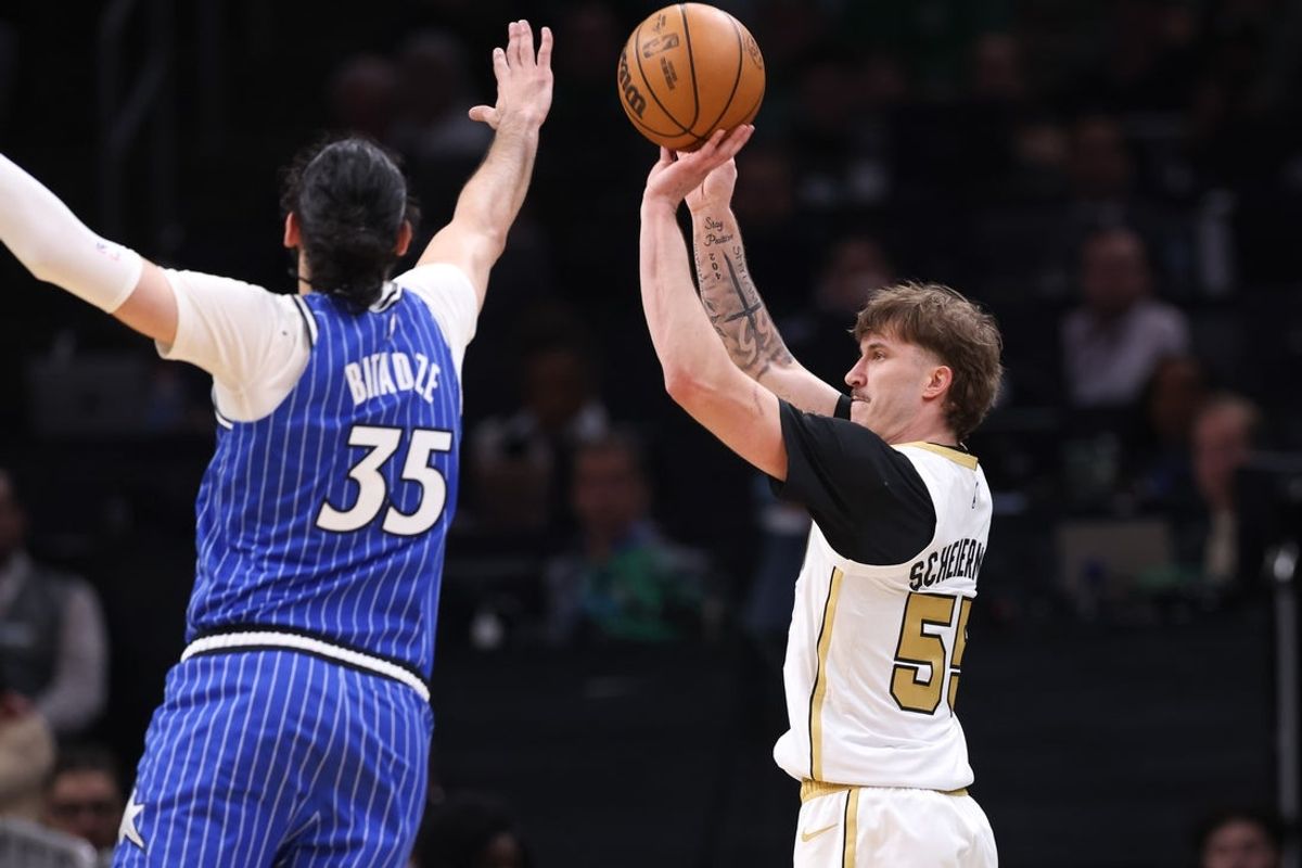 Apr 12, 2026; Boston, Massachusetts, USA; Boston Celtics guard Baylor Scheierman (55) shoots over Orlando Magic center Goga Bitadze (35) during the first half at TD Garden. Mandatory Credit: Paul Rutherford-Imagn Images