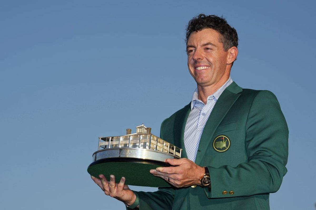 Apr 12, 2026; Augusta, Georgia, USA; Rory McIlroy holds the Masters championship trophy during the green jacket ceremony after the final round of the Masters Tournament at Augusta National Golf Club. Mandatory Credit: Kyle Terada-Imagn Images
