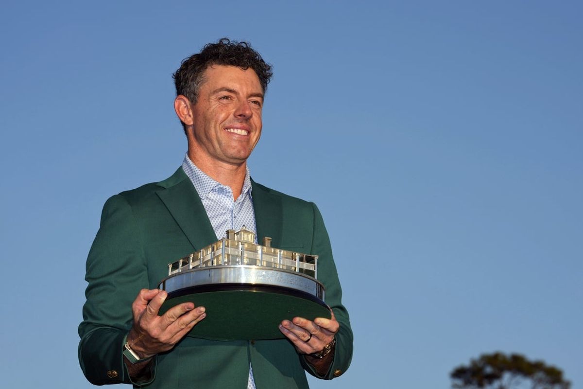 Apr 12, 2026; Augusta, Georgia, USA; Rory McIlroy holds the Masters championship trophy during the green jacket ceremony after the final round of the Masters Tournament at Augusta National Golf Club. Mandatory Credit: Kyle Terada-Imagn Images