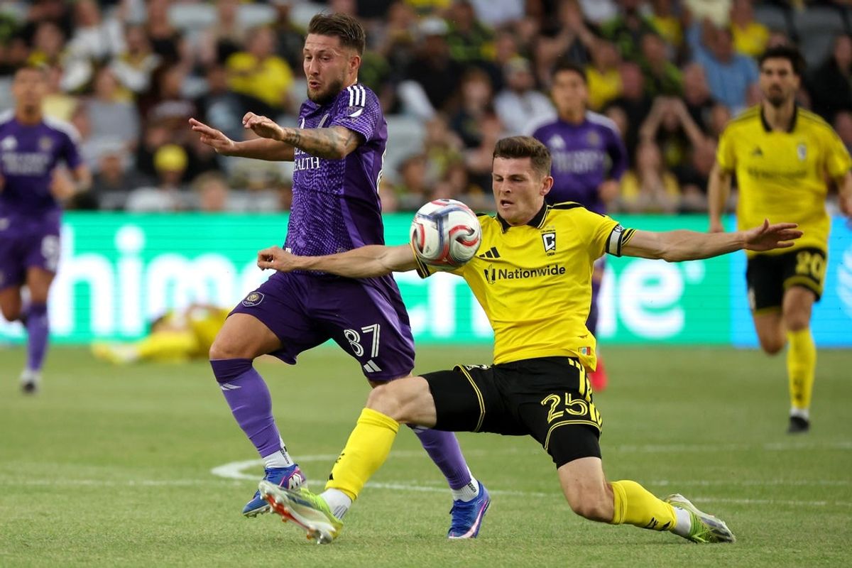 Apr 12, 2026; Columbus, Ohio, USA;  Columbus Crew midfielder Sean Zawadzki (25) kicks the ball in front of Orlando City SC midfielder Marco Pasalic (87) during the first half at ScottsMiracle-Gro Field. Mandatory Credit: Joseph Maiorana-Imagn Images