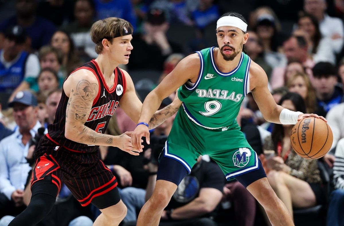 Apr 12, 2026; Dallas, Texas, USA;  Dallas Mavericks guard Ryan Nembhard (9) dribbles as Chicago Bulls guard Mac McClung (5) defends during the first half at American Airlines Center. Mandatory Credit: Kevin Jairaj-Imagn Images