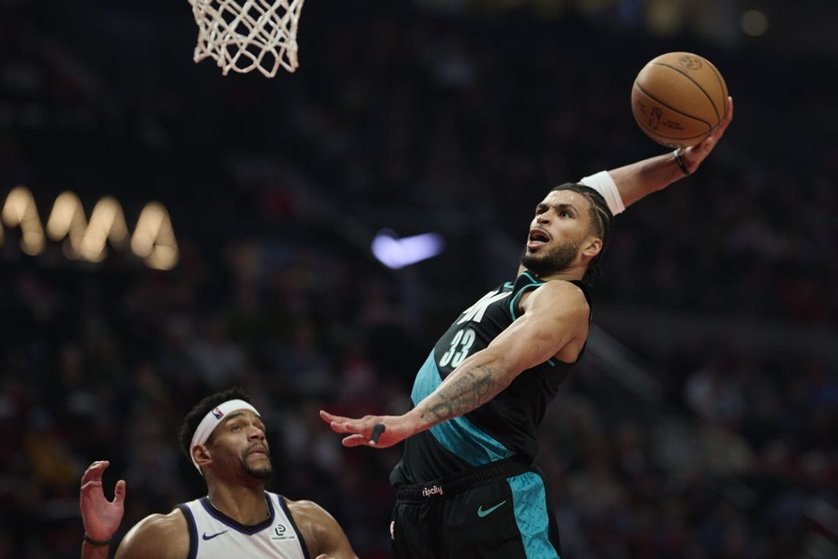 Apr 12, 2026; Portland, Oregon, USA; Portland Trail Blazers forward Toumani Camara (33) dunks the basketball over Sacramento Kings center Dylan Cardwell (32) during the first half at Moda Center. Mandatory Credit: Troy Wayrynen-Imagn Images