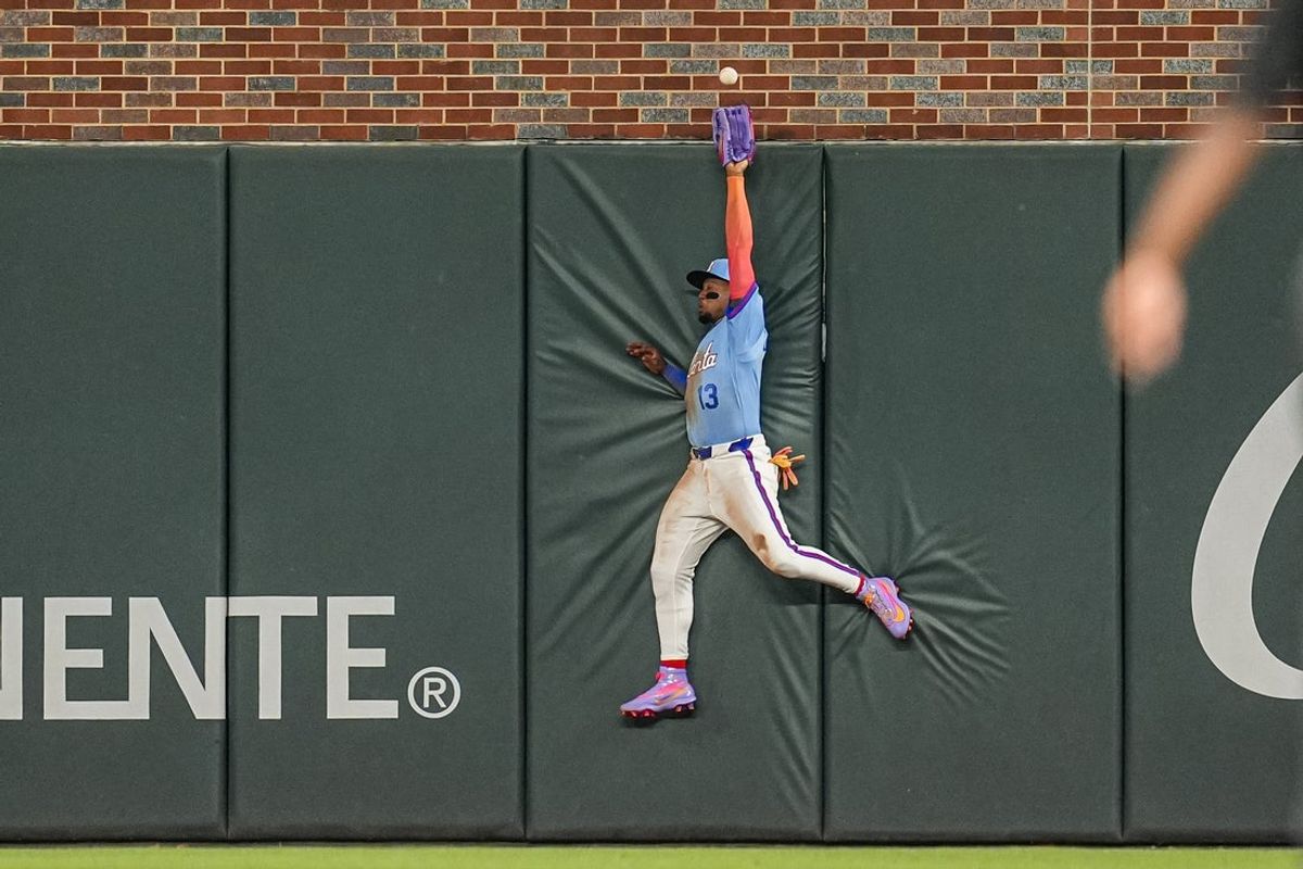 Apr 12, 2026; Cumberland, Georgia, USA; Atlanta Braves right fielder Ronald Acuña Jr. (13) tries to catch a ball hit by Cleveland Guardians center fielder Daniel Schneemann (10) (not shown) during the ninth inning at Truist Park. Mandatory Credit: Dale Zanine-Imagn Images