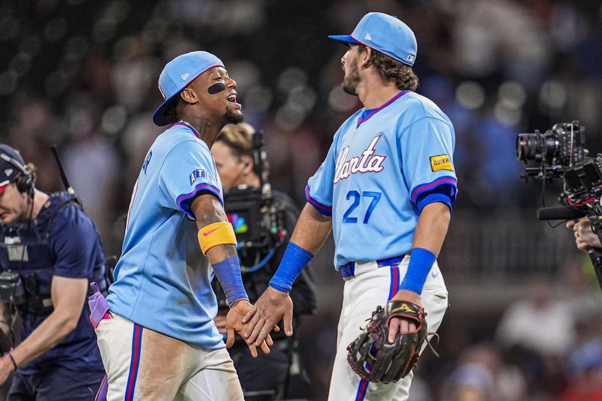 Apr 12, 2026; Cumberland, Georgia, USA; Atlanta Braves right fielder Ronald Acuna Jr. (13) and third baseman Austin Riley (27) react after defeating the Cleveland Guardians at Truist Park. Mandatory Credit: Dale Zanine-Imagn Images