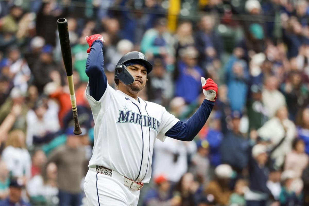 Apr 13, 2026; Seattle, Washington, USA; Seattle Mariners first baseman Josh Naylor (12) flips his bat after hitting a two-run home run against the Houston Astros during the third inning at T-Mobile Park. Mandatory Credit: Joe Nicholson-Imagn Images