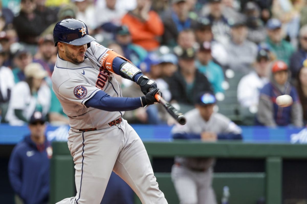 Apr 13, 2026; Seattle, Washington, USA; Houston Astros catcher Yainer Diaz (21) hits an RBI-single against the Seattle Mariners during the fifth inning at T-Mobile Park. Mandatory Credit: Joe Nicholson-Imagn Images