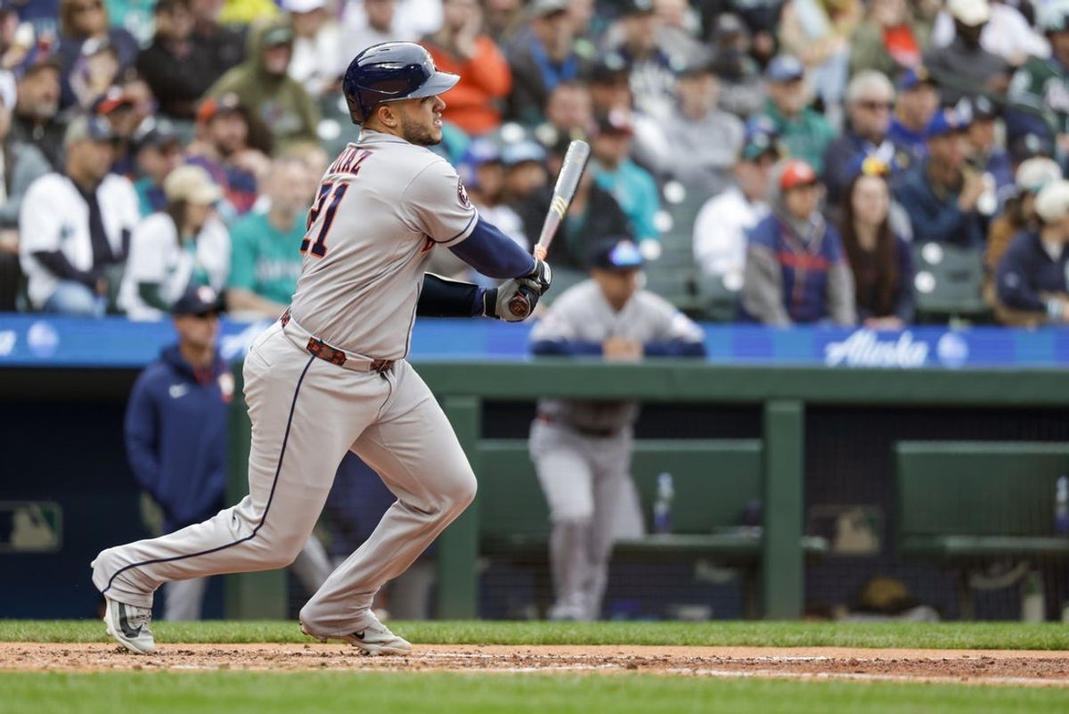 Apr 13, 2026; Seattle, Washington, USA; Houston Astros catcher Yainer Diaz (21) hits an RBI-single against the Seattle Mariners during the fifth inning at T-Mobile Park. Mandatory Credit: Joe Nicholson-Imagn Images