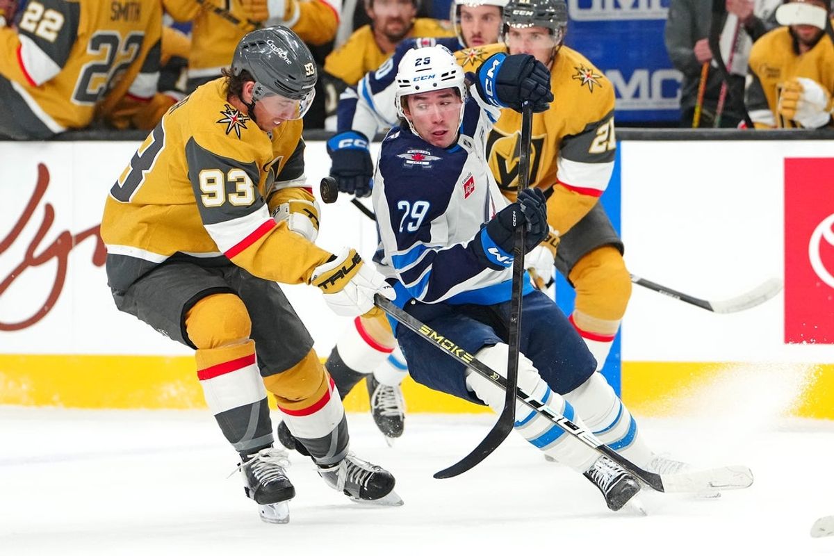 Apr 13, 2026; Las Vegas, Nevada, USA; Winnipeg Jets center Brayden Yager (29) eyes a loose puck in front of Vegas Golden Knights right wing Mitch Marner (93) during the first period at T-Mobile Arena. Mandatory Credit: Stephen R. Sylvanie-Imagn Images