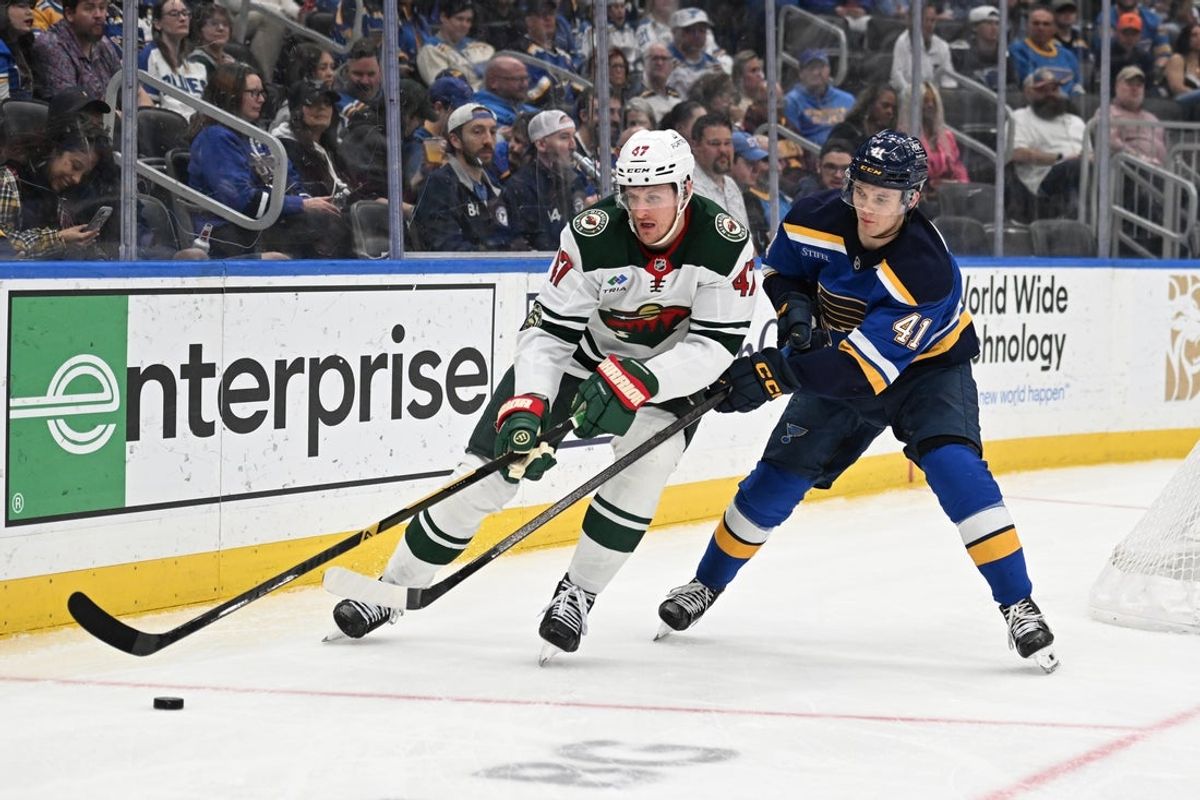 Apr 13, 2026; St. Louis, Missouri, USA; St. Louis Blues defenseman Theo Lindstein (41) defends against Minnesota Wild center Michael McCarron (47) in the third period at Enterprise Center. Mandatory Credit: Joe Puetz-Imagn Images