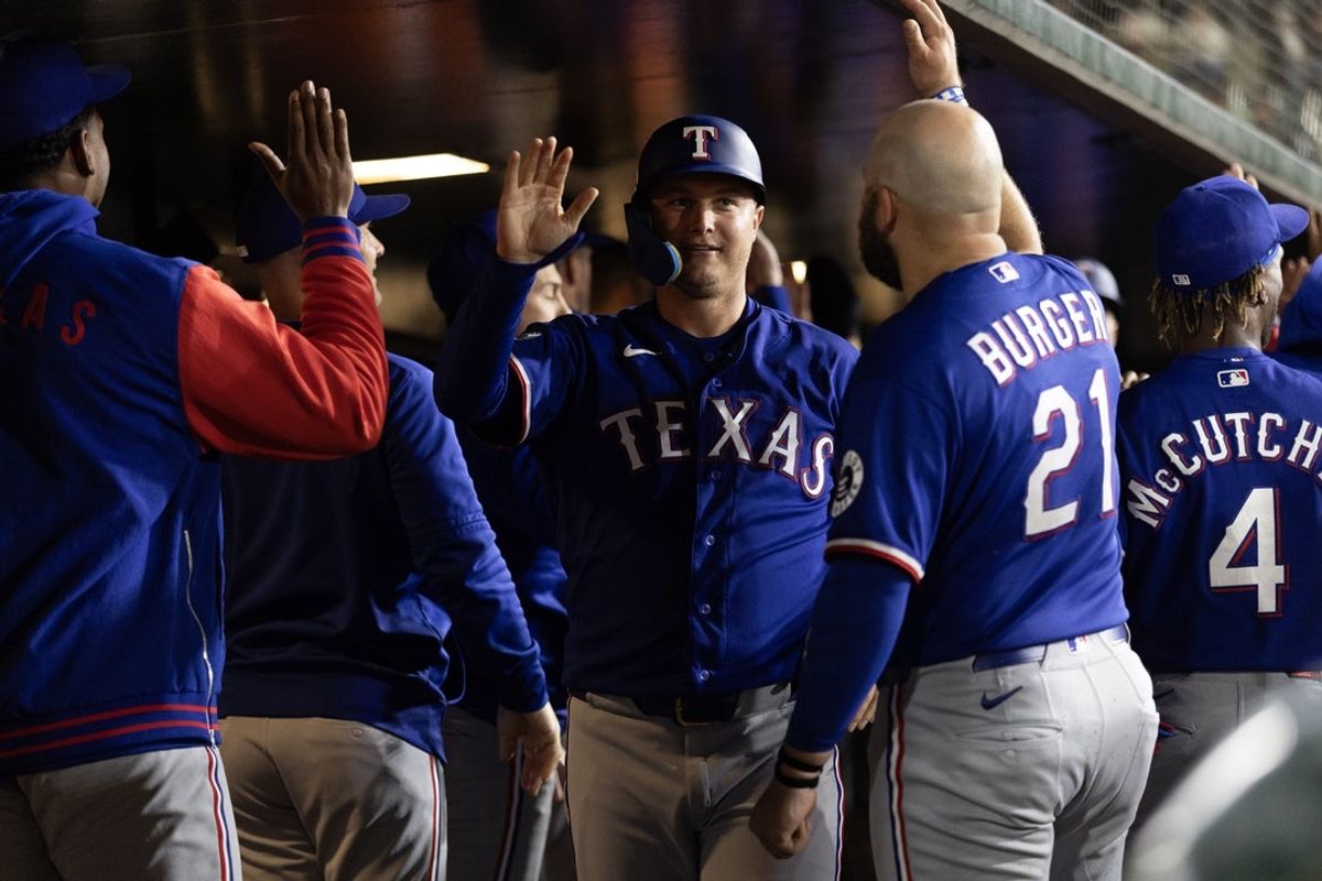 Apr 13, 2026; West Sacramento, California, USA; Texas Rangers designated hitter Joc Pederson (facing) is greeted by his teammates after scoring against the Athletics during the eighth inning at Sutter Health Park. Mandatory Credit: D. Ross Cameron-Imagn Images