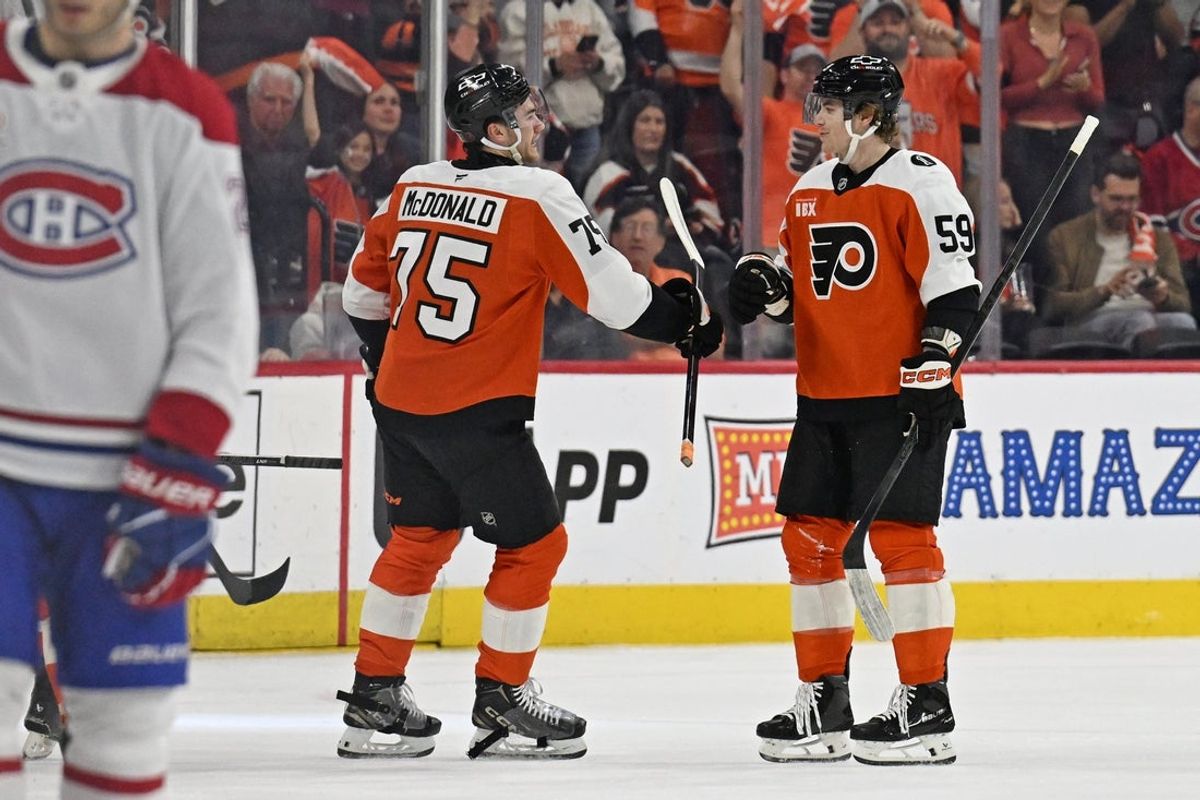 Apr 14, 2026; Philadelphia, Pennsylvania, USA; Philadelphia Flyers defenseman Oliver Bonk (59) celebrates his goal defenseman Hunter McDonald (75) against the Montréal Canadiens during the first period at Xfinity Mobile Arena. Mandatory Credit: Eric Hartline-Imagn Images