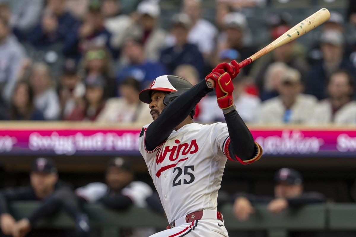 Apr 14, 2026; Minneapolis, Minnesota, USA; Minnesota Twins center fielder Byron Buxton (25) hits a single against the Boston Red Sox in the first inning at Target Field. Mandatory Credit: Jesse Johnson-Imagn Images
