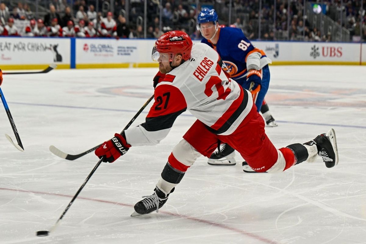 Apr 14, 2026; Elmont, New York, USA;  Carolina Hurricanes left wing Nikolaj Ehlers (27) attempts a shot against the New York Islanders during the third period at UBS Arena. Mandatory Credit: Dennis Schneidler-Imagn Images