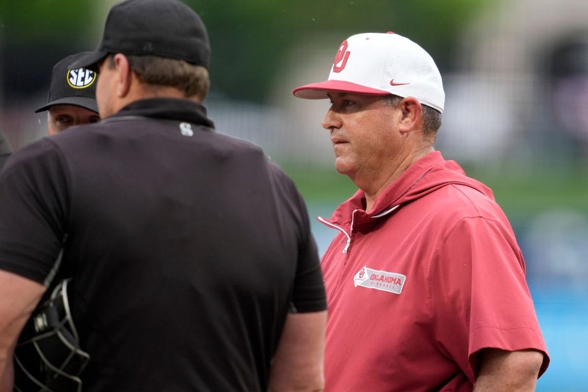 Oklahoma coach Skip Johnson talks with officials before a Bedlam baseball game between the Oklahoma State Cowboys and the Oklahoma Sooners at ONEOK Field in Tulsa, Okla., Tuesday, April 14, 2026.