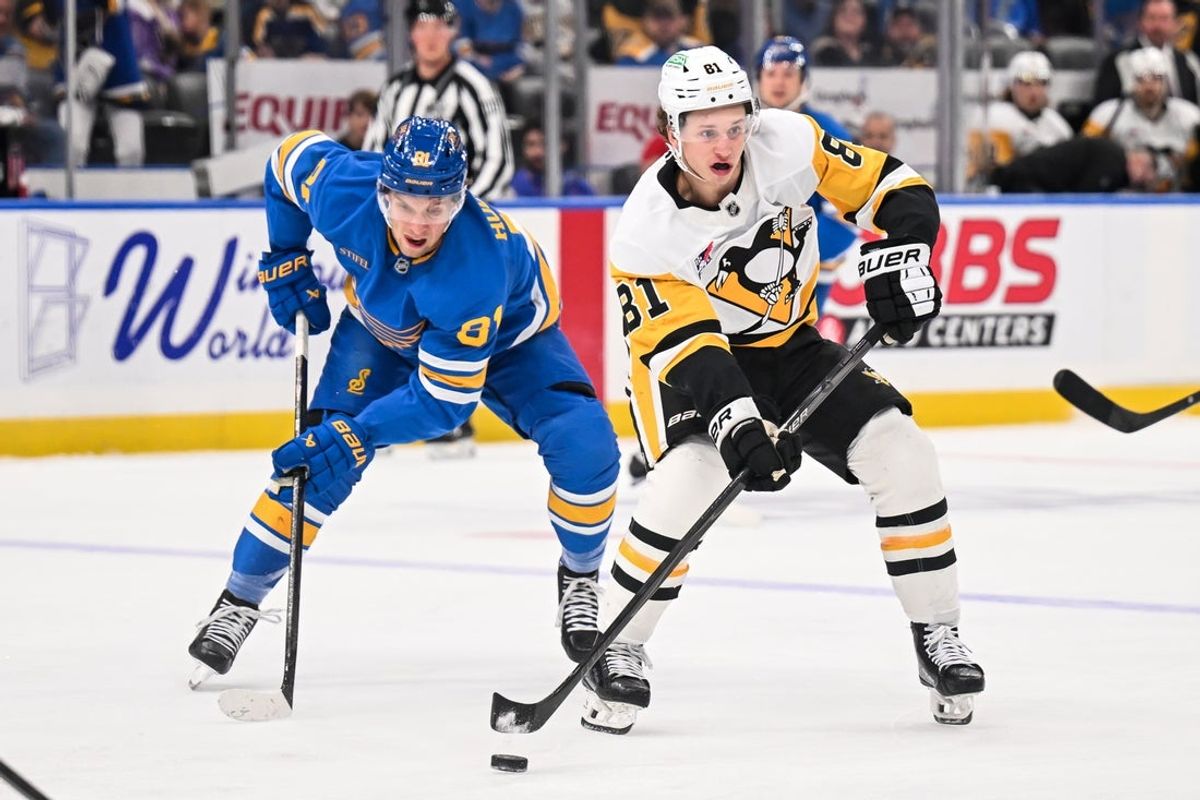 Apr 14, 2026; St. Louis, Missouri, USA; Pittsburgh Penguins center Ben Kindel (81) controls the puck while under pressure from St. Louis Blues left wing Dylan Holloway (81) during the first period at Enterprise Center. Mandatory Credit: Connor Hamilton-Imagn Images