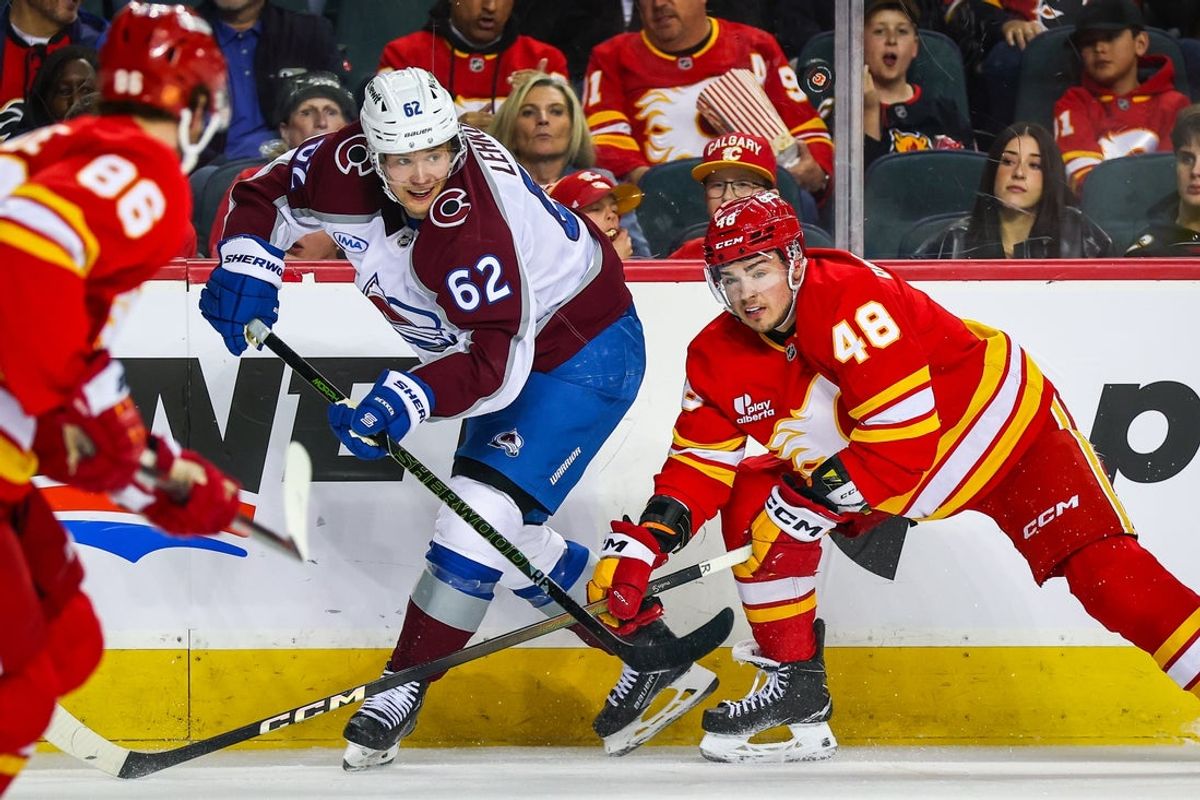 Apr 14, 2026; Calgary, Alberta, CAN; Colorado Avalanche left wing Artturi Lehkonen (62) and Calgary Flames defenseman Hunter Brzustewicz (48) battle for the puck during the second period at Scotiabank Saddledome. Mandatory Credit: Sergei Belski-Imagn Images