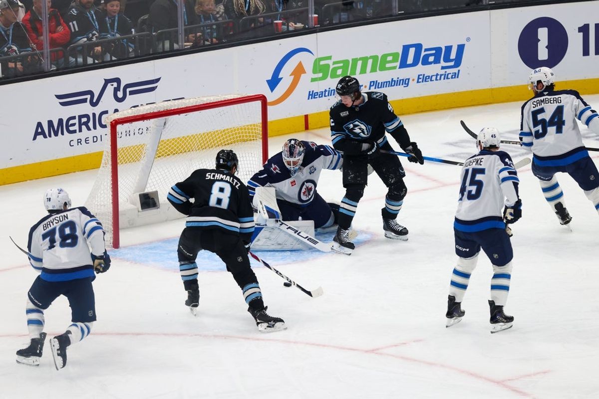 Apr 14, 2026; Salt Lake City, Utah, USA; Utah Mammoth center Nick Schmaltz (8) shoots and scores against Winnipeg Jets goaltender Eric Comrie (1) during the second period at Delta Center. Mandatory Credit: Rob Gray-Imagn Images