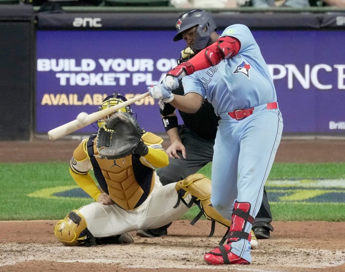 Toronto Blue Jays first baseman Vladimir Guerrero Jr. (27) hits an RBI double during the 10th inning of their game against the Milwaukee Brewers Tuesday, April 14, 2026 at American Family Field in Milwaukee, Wisconsin.