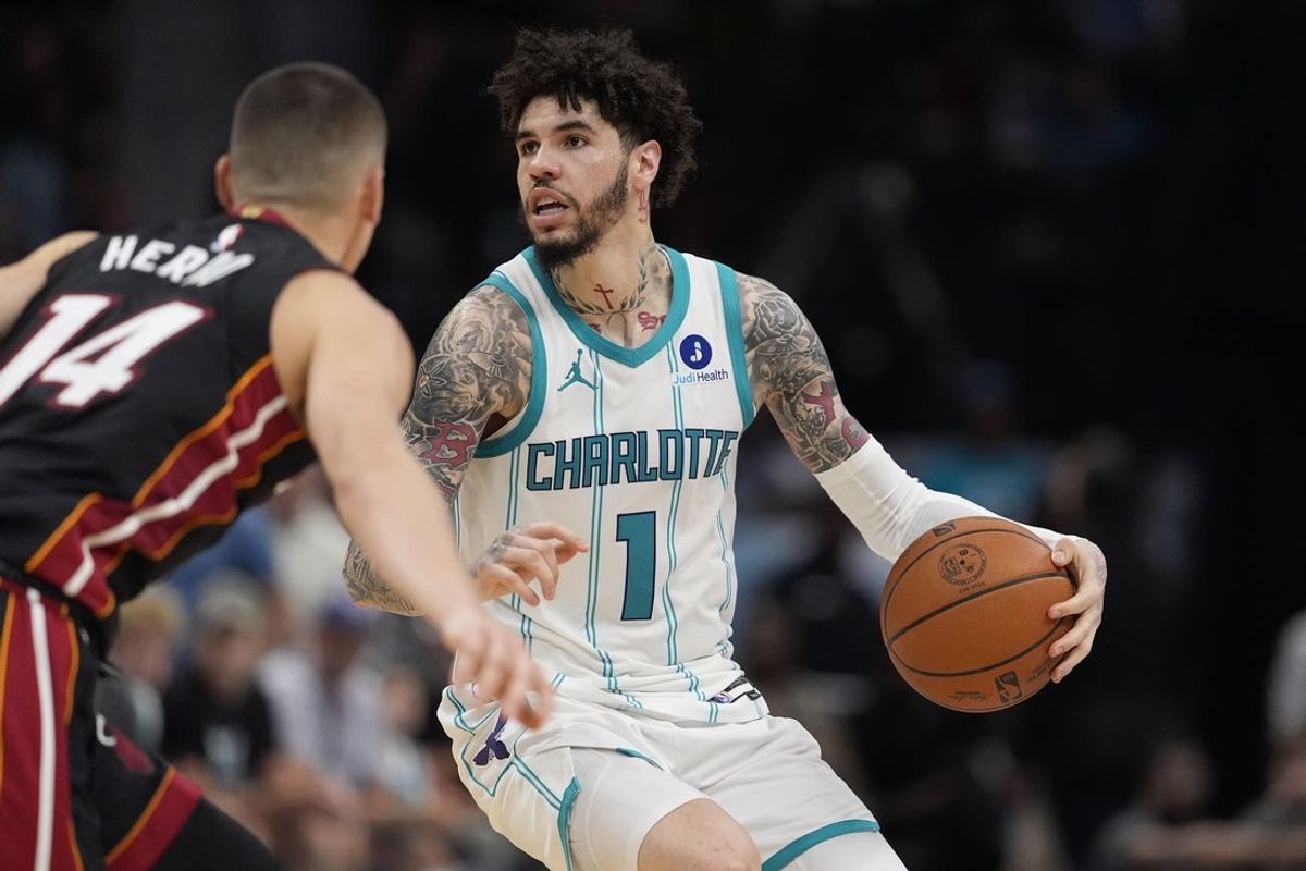 Apr 14, 2026; Charlotte, North Carolina, USA; Charlotte Hornets guard LaMelo Ball (1) looks to pass defended by Miami Heat guard Tyler Herro (14) during the second half during the play-in rounds between the Charlotte Hornets and the Miami Heat of the 2026 NBA Playoffs at Spectrum Center. Mandatory Credit: Jim Dedmon-Imagn Images