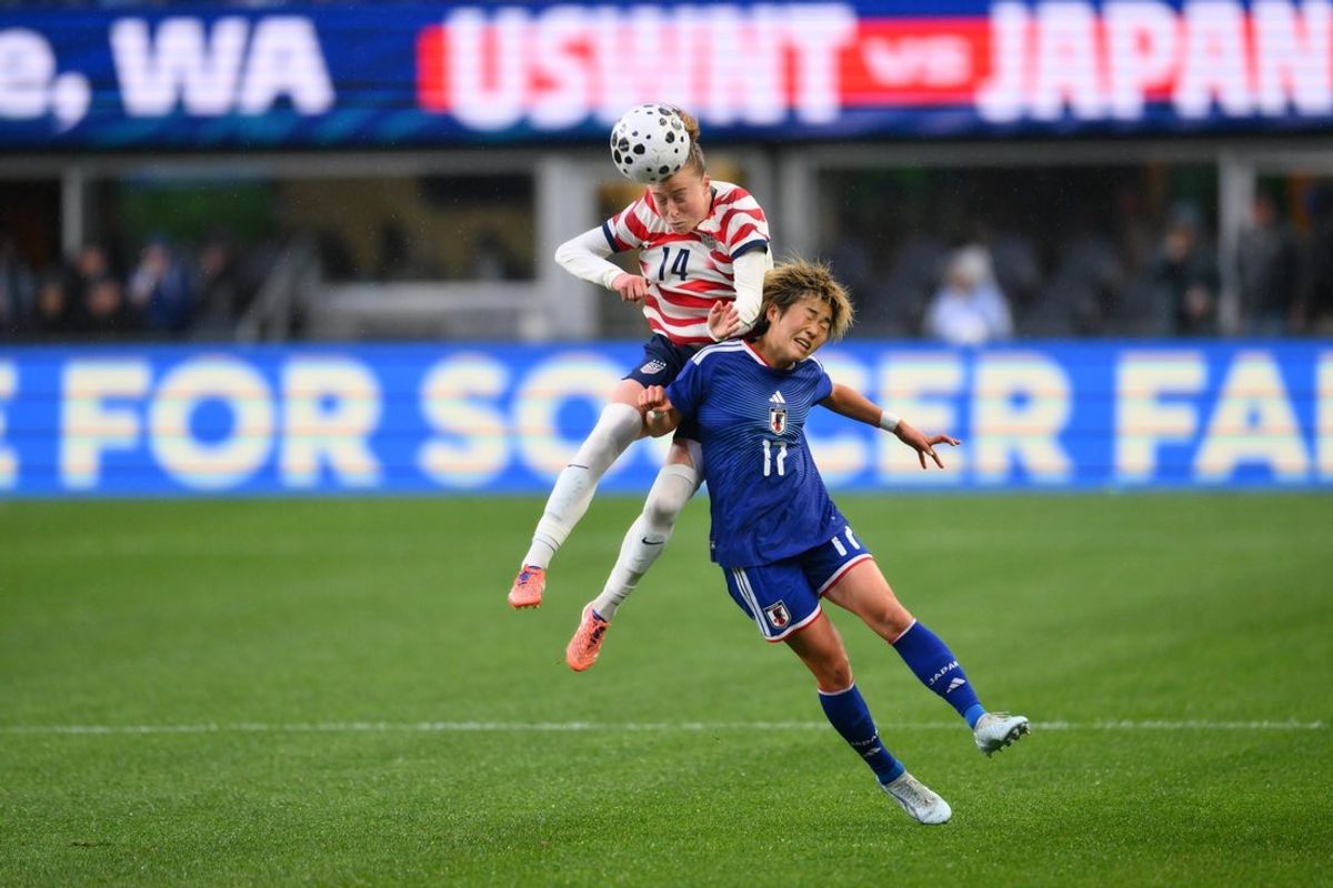 Apr 14, 2026; Seattle, WA, USA; United States defender Emily Sonnett (14) heads the ball over Japan forward Maika Hamano (17) during the first half at Lumen Field. Mandatory Credit: Steven Bisig-Imagn Images
