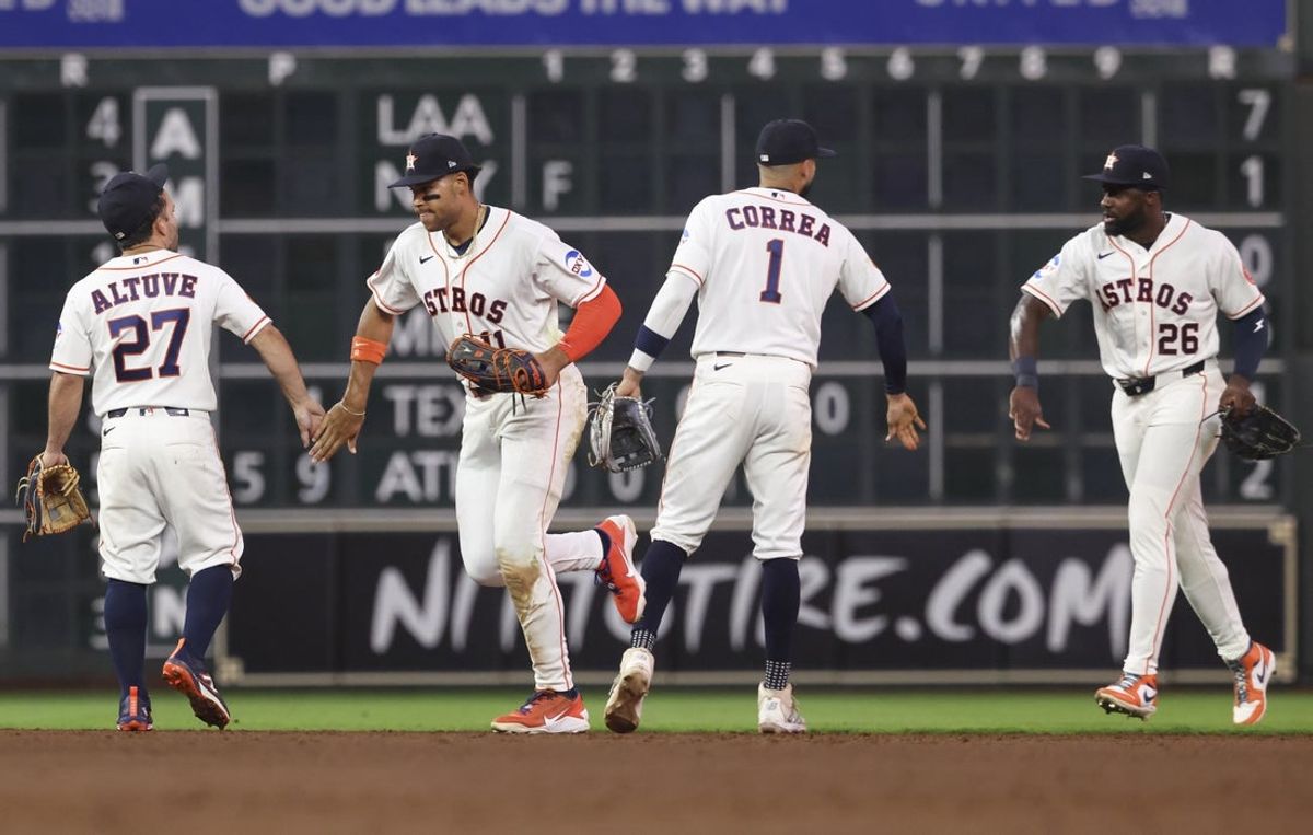 Apr 14, 2026; Houston, Texas, USA; Houston Astros second baseman Jose Altuve (27) and right fielder Cam Smith (11) and shortstop Carlos Correa (1) and left fielder Taylor Trammell (26) celebrate after the game against the Colorado Rockies at Daikin Park. Mandatory Credit: Troy Taormina-Imagn Images