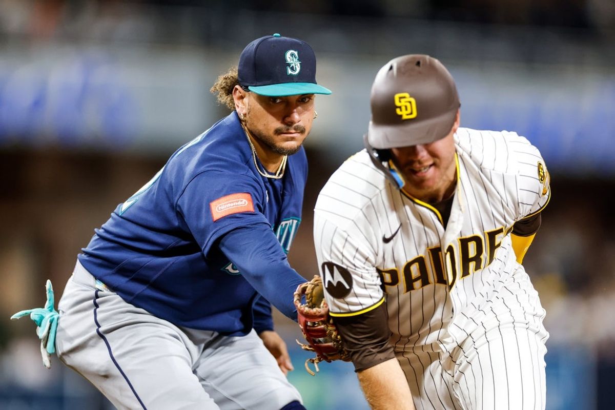 Apr 14, 2026; San Diego, California, USA; Seattle Mariners first baseman Josh Naylor (12) tags out San Diego Padres designated hitter Gavin Sheets (30) to turn a double play during the sixth inning at Petco Park. Mandatory Credit: David Frerker-Imagn Images