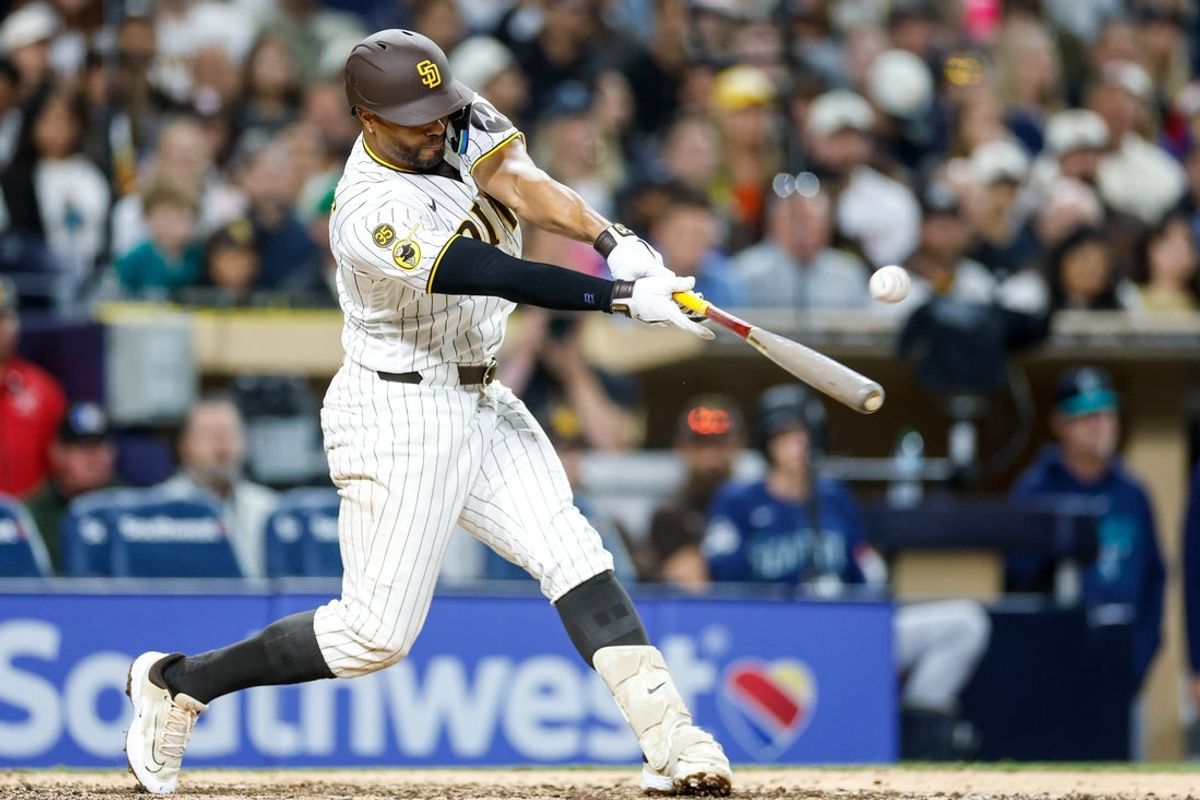 Apr 14, 2026; San Diego, California, USA; San Diego Padres shortstop Xander Bogaerts (2) hits a RBI single during the eighth inning against the Seattle Mariners at Petco Park. Mandatory Credit: David Frerker-Imagn Images