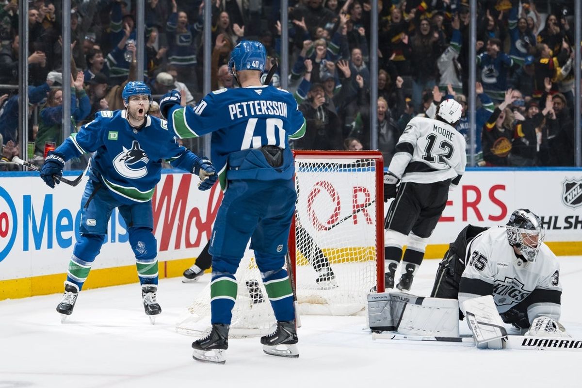 Apr 14, 2026; Vancouver, British Columbia, CAN; Los Angeles Kings goalie Darcy Kuemper (35) and forward Trevor Moore (12) react as Vancouver Canucks forward Elias Pettersson (40) and forward Jake DeBrusk (74) celebrate DeBrusk’s game winning overtime goal in the third period at Rogers Arena. Mandatory Credit: Bob Frid-Imagn Images