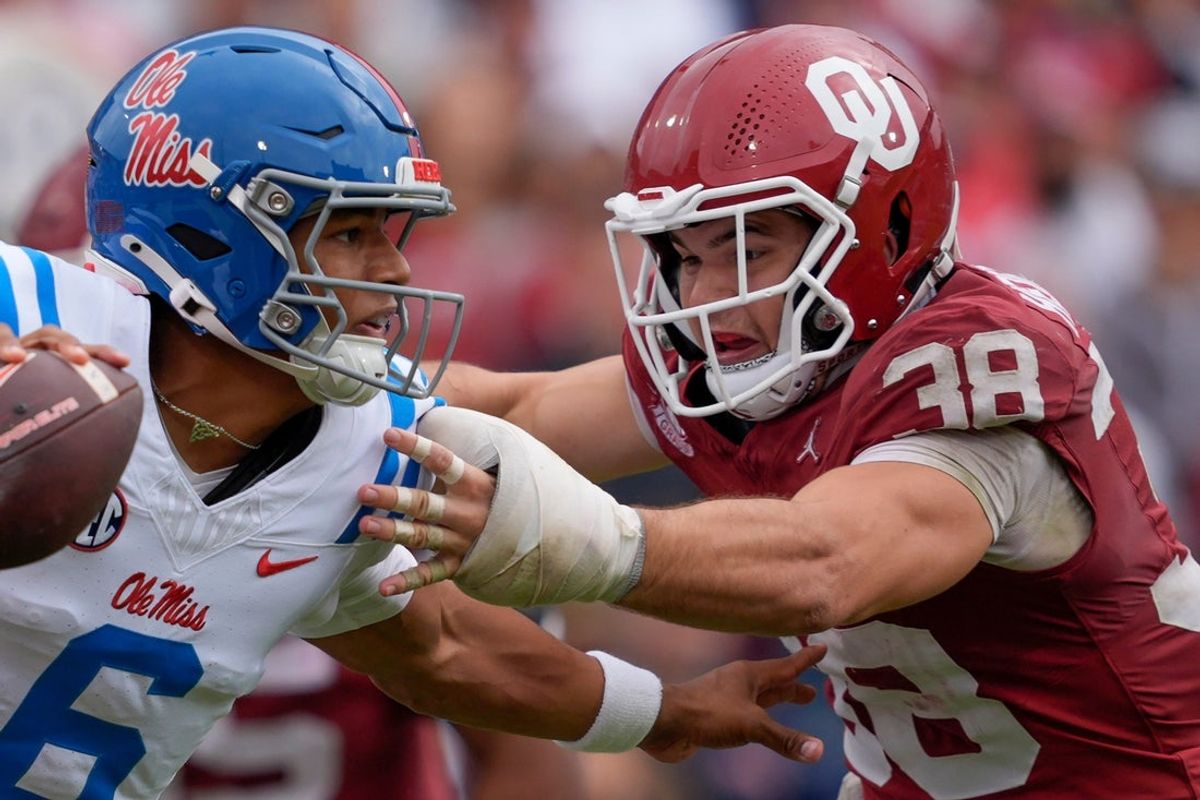 Oklahoma Sooners linebacker Owen Heinecke (38) runs after Ole Miss Rebels quarterback Trinidad Chambliss (6) during a college football game between the University of Oklahoma Sooners (OU) and the Ole Miss Rebels at Gaylord Family-Oklahoma Memorial Stadium in Norman, Okla., Saturday, Oct. 25, 2025. Ole Miss won 34-26.