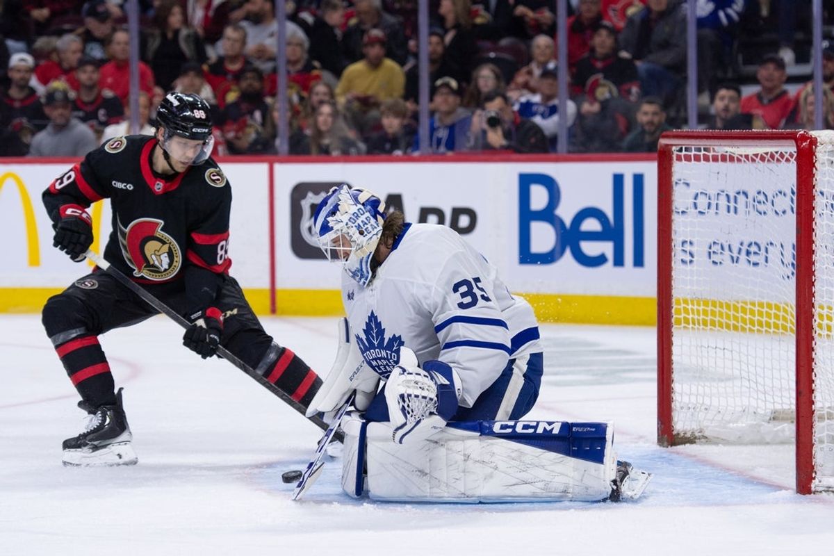 Apr 15, 2026; Ottawa, Ontario, CAN; Toronto Maple Leafs goalie Dennis Hildeby (35) makes a save in front of Ottawa Senators center Lars Eller (89) in the first period at the Canadian Tire Centre. Mandatory Credit: Marc DesRosiers-IMAGN Images