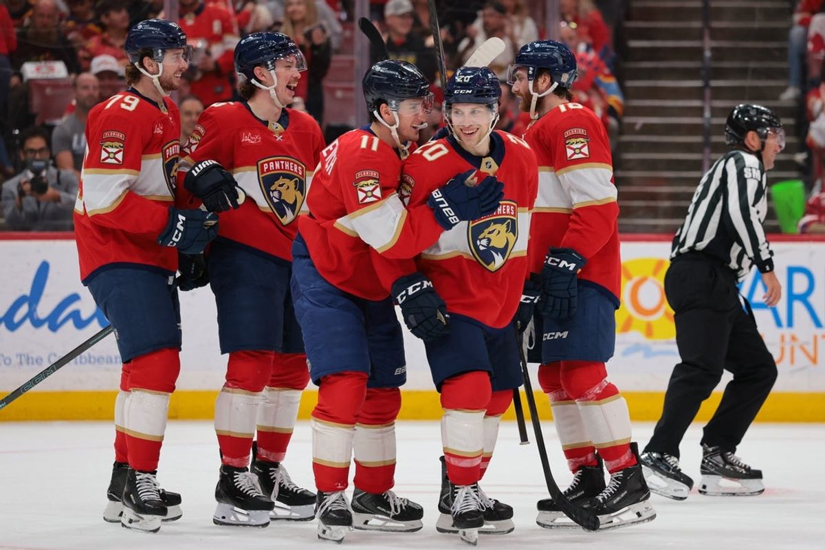 Apr 15, 2026; Sunrise, Florida, USA; Florida Panthers defenseman Mike Benning (20) celebrates with right wing MacKie Samoskevich (11) after scoring against the Detroit Red Wings during the second period at Amerant Bank Arena. Mandatory Credit: Sam Navarro-Imagn Images
