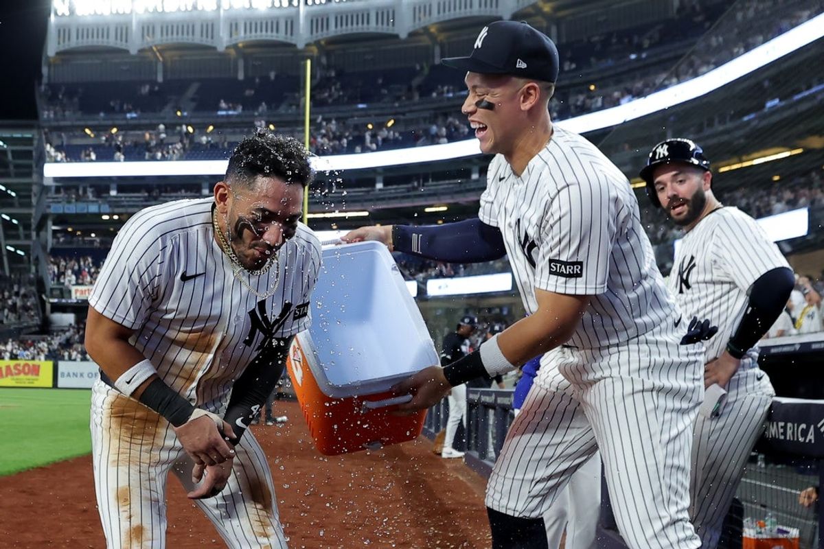 Apr 15, 2026; Bronx, New York, USA; New York Yankees shortstop Jose Caballero reacts after being doused by right fielder Aaron Judge after his ninth inning two run walkoff hit against the Los Angeles Angels at Yankee Stadium. All MLB players are wearing number 42 today to honor Jackie Robinson. Mandatory Credit: Brad Penner-Imagn Images