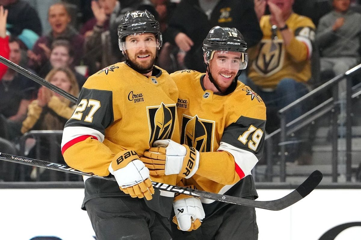Apr 15, 2026; Las Vegas, Nevada, USA; Vegas Golden Knights defenseman Shea Theodore (27) celebrates with right wing Reilly Smith (19) after scoring a goal against the Seattle Kraken during the second period at T-Mobile Arena. Mandatory Credit: Stephen R. Sylvanie-Imagn Images