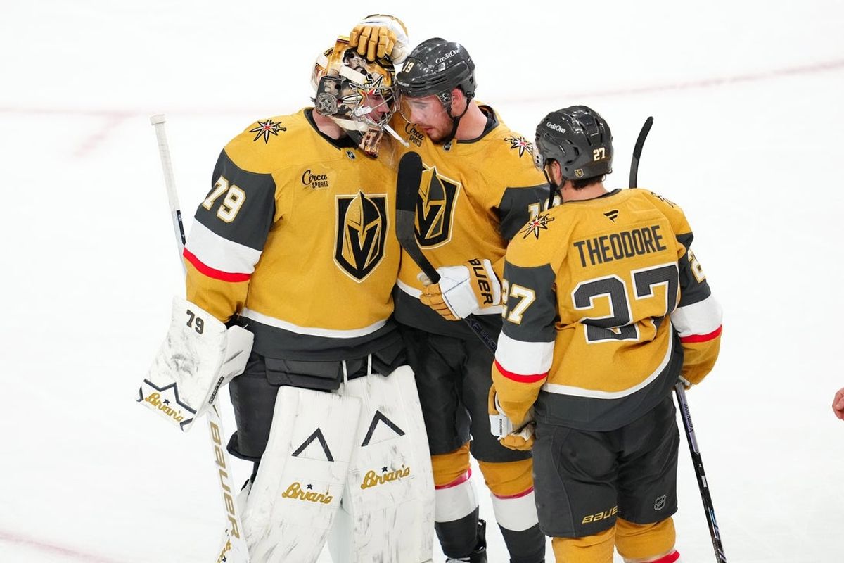 Apr 15, 2026; Las Vegas, Nevada, USA; Vegas Golden Knights goaltender Carter Hart (79) celebrates with right wing Reilly Smith (19) and defenseman Shea Theodore (27) after the Golden Knights defeated the Seattle Kraken 4-1 at T-Mobile Arena. Mandatory Credit: Stephen R. Sylvanie-Imagn Images