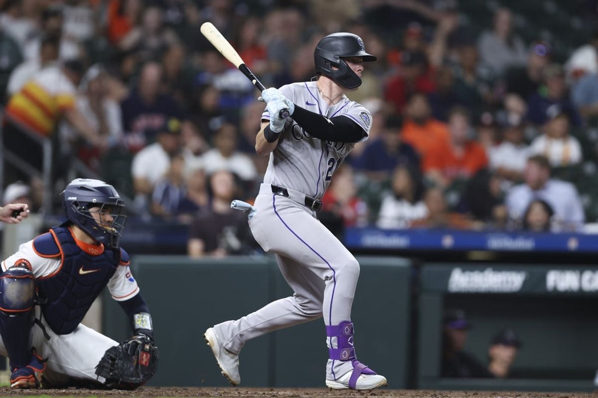 Apr 16, 2026; Houston, Texas, USA; Colorado Rockies designated hitter Troy Johnston (20) hits a single during the fourth inning against the Houston Astros at Daikin Park. Mandatory Credit: Troy Taormina-Imagn Images