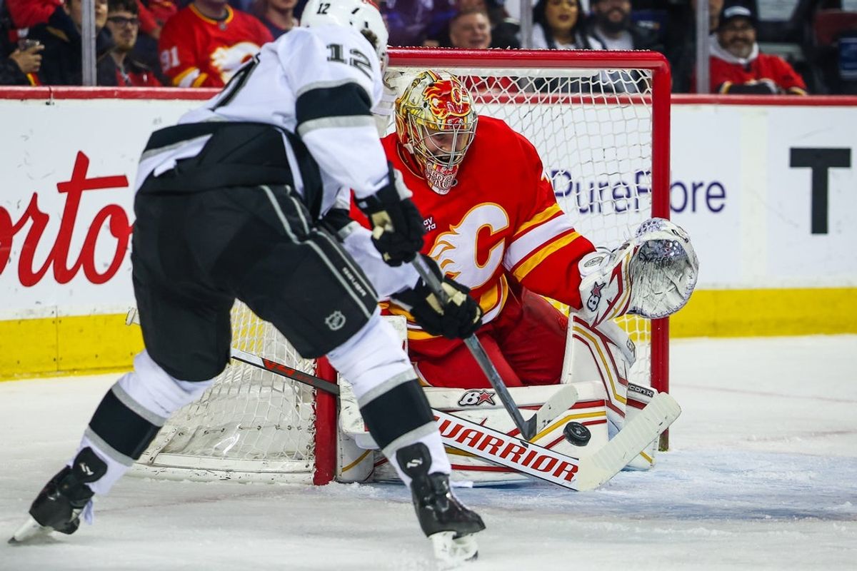 Apr 16, 2026; Calgary, Alberta, CAN; Calgary Flames goaltender Arsenii Sergeev (40) makes a save against Los Angeles Kings left wing Trevor Moore (12) during the first period at Scotiabank Saddledome. Mandatory Credit: Sergei Belski-Imagn Images