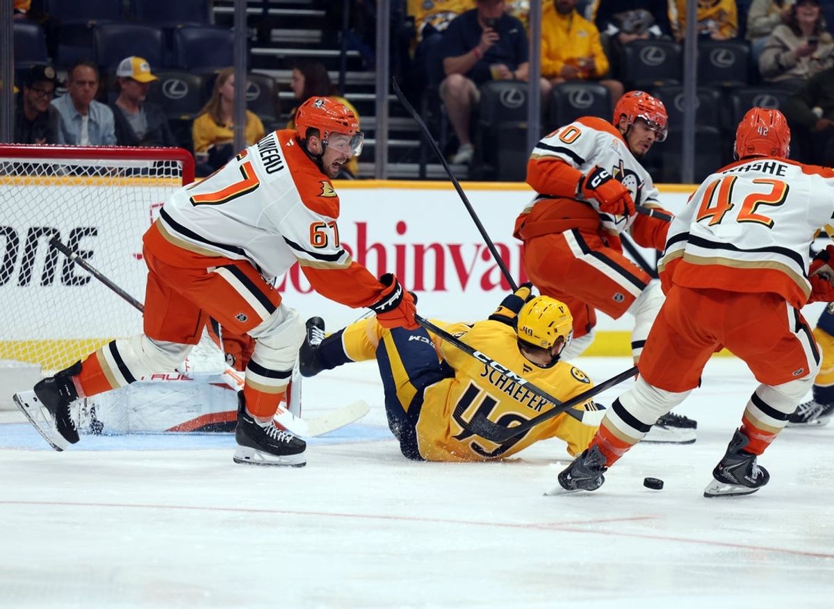 Apr 16, 2026; Nashville, Tennessee, USA; Anaheim Ducks defenseman Tristan Luneau (67) and center Tim Washe (42) defend against an attack by Nashville Predators left wing Reid Schaefer (49) during the second period of their game at Bridgestone Arena. Mandatory Credit: Alan Poizner-Imagn Images