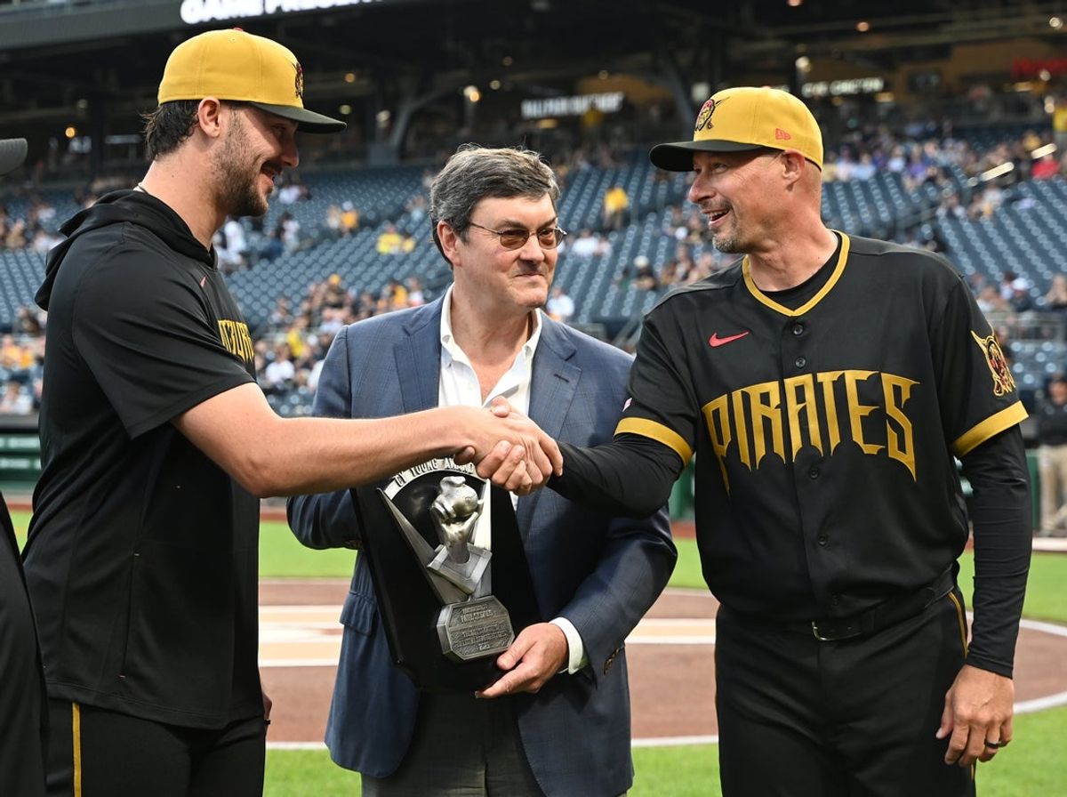 Apr 17, 2026; Pittsburgh, Pennsylvania, USA;  Pittsburgh Pirates starting pitcher Paul Skenes (left) shakes the hand of manager Don Kelly, right, upon accepting his Cy Young Award from owner Bob Nutting before a game against the Tampa Bay Rays  Tampa Bay Rays at PNC Park. Mandatory Credit: Philip G. Pavely-Imagn Images