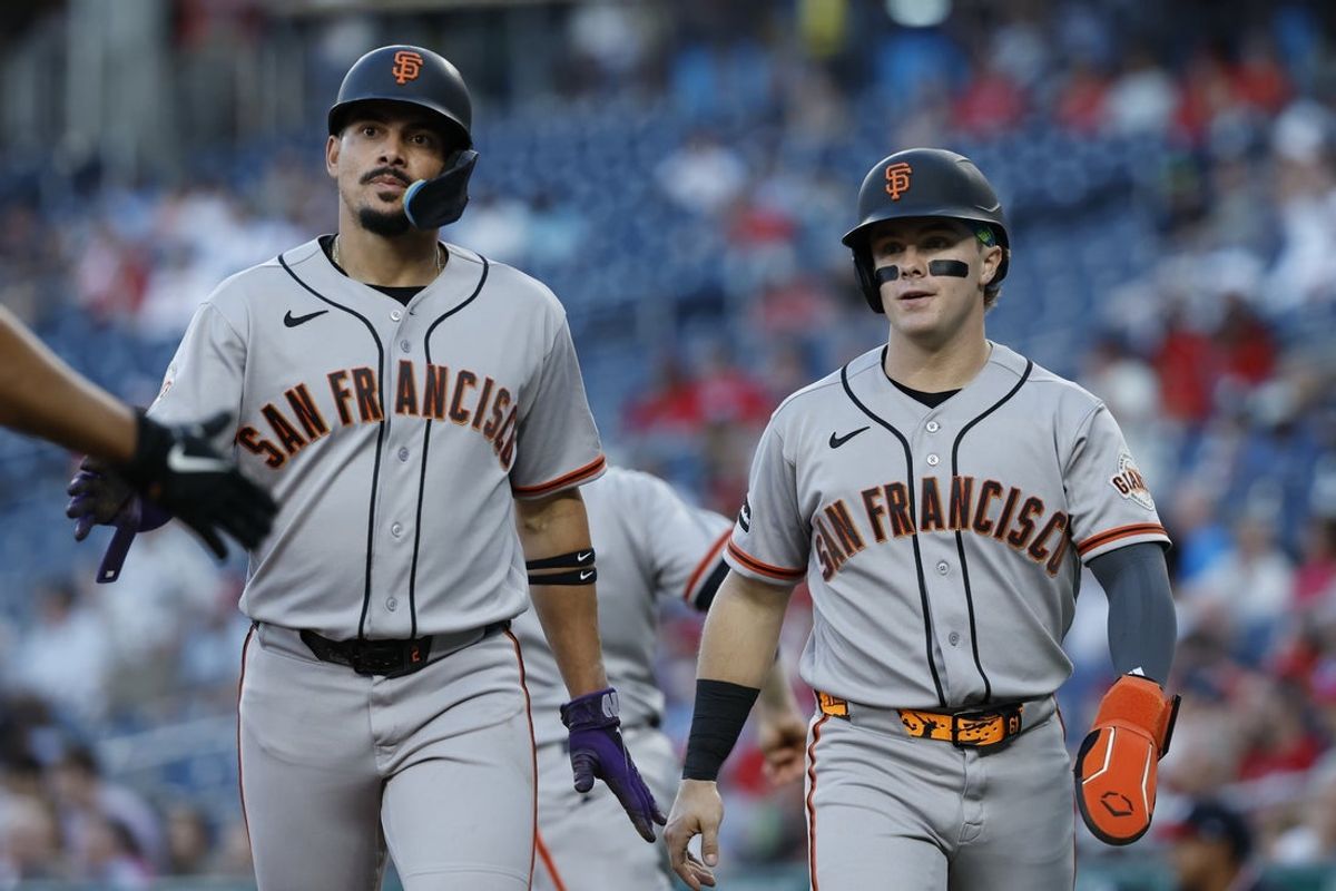 Apr 17, 2026; Washington, District of Columbia, USA; San Francisco Giants infielder Luis Arraez (L) and Giants center fielder Drew Gilbert (R) walk back to the dugout after scoring runs on a two run single by Giants third baseman Matt Chapman (not pictured) against the Washington Nationals during the second inning at Nationals Park. Mandatory Credit: Geoff Burke-Imagn Images