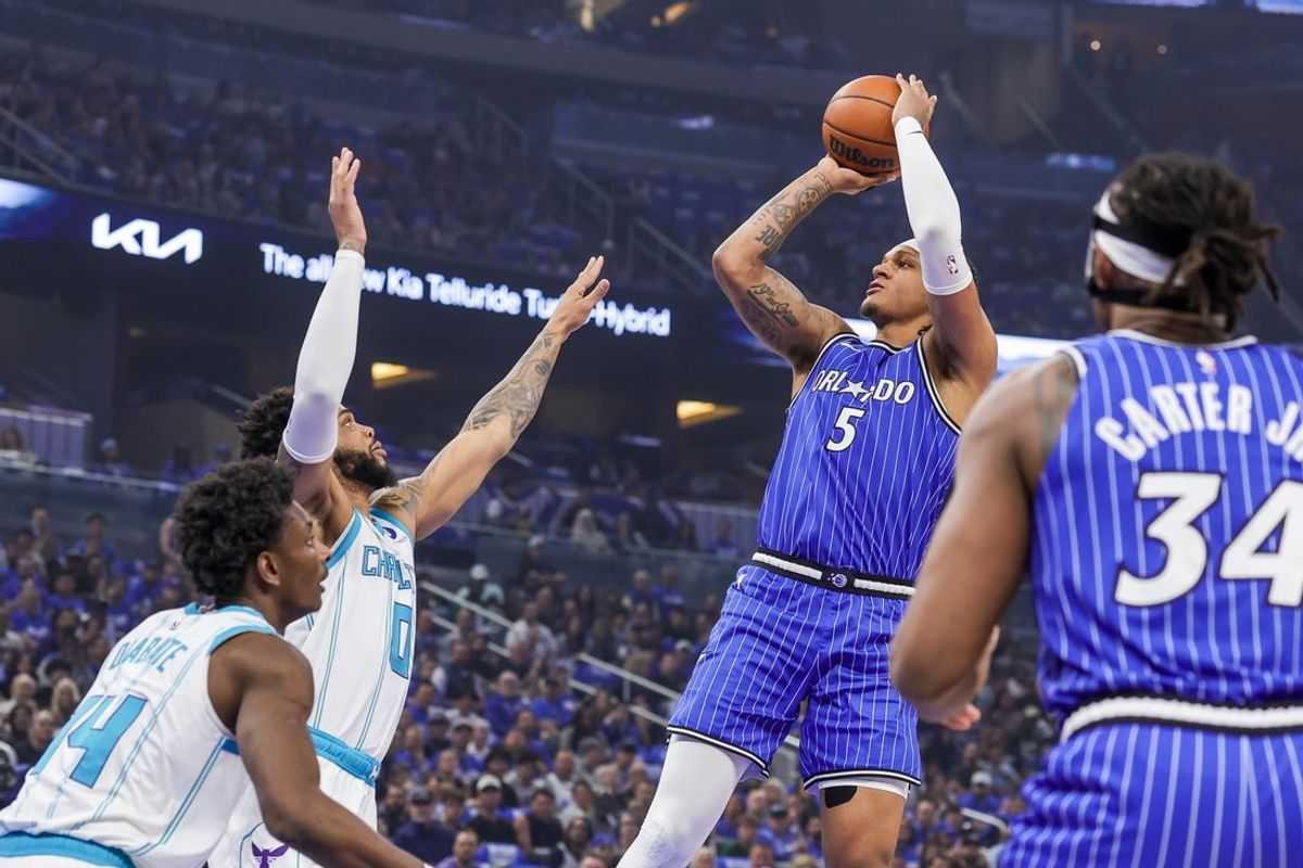Apr 17, 2026; Orlando, Florida, USA; Orlando Magic forward Paolo Banchero (5) shoots against Charlotte Hornets forward Miles Bridges (0) during the first quarter during the play-in rounds of the 2026 NBA Playoffs at Kia Center. Mandatory Credit: Mike Watters-Imagn Images