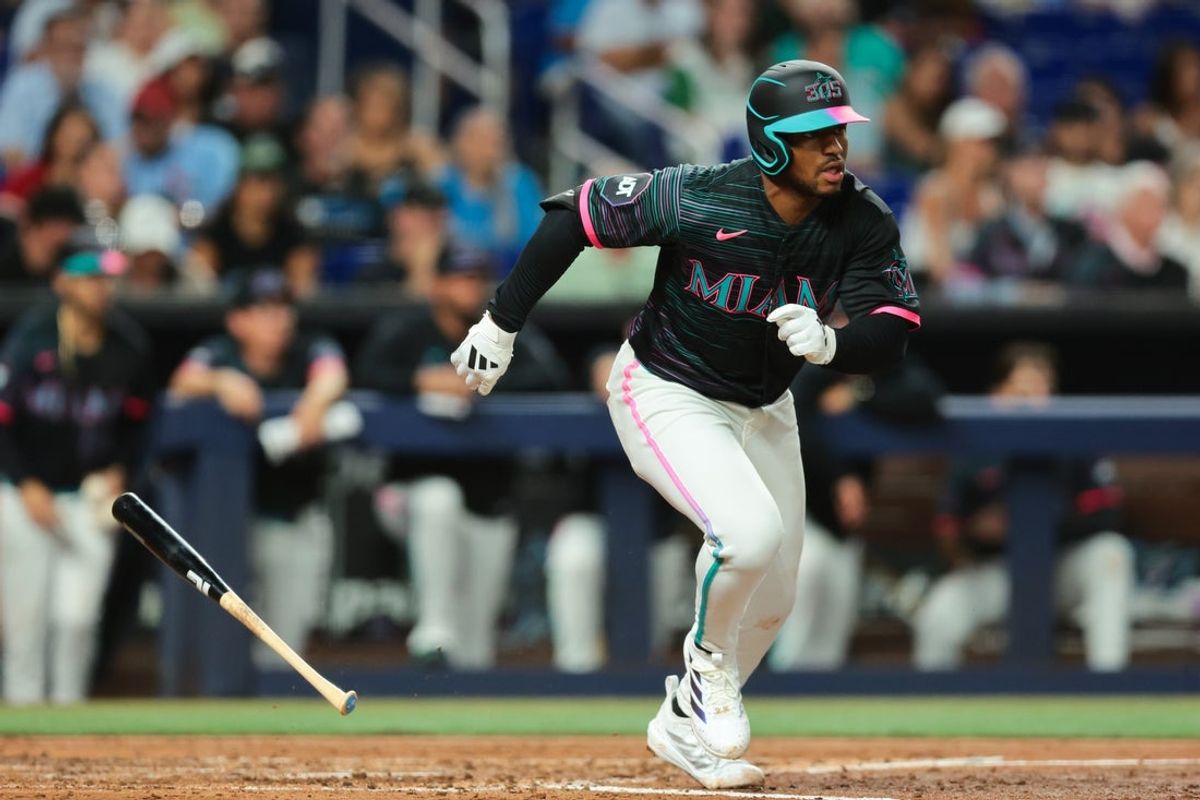 Apr 17, 2026; Miami, Florida, USA; Miami Marlins second baseman Xavier Edwards (9) hits a single against the Milwaukee Brewers during the third inning at loanDepot Park. Mandatory Credit: Sam Navarro-Imagn Images